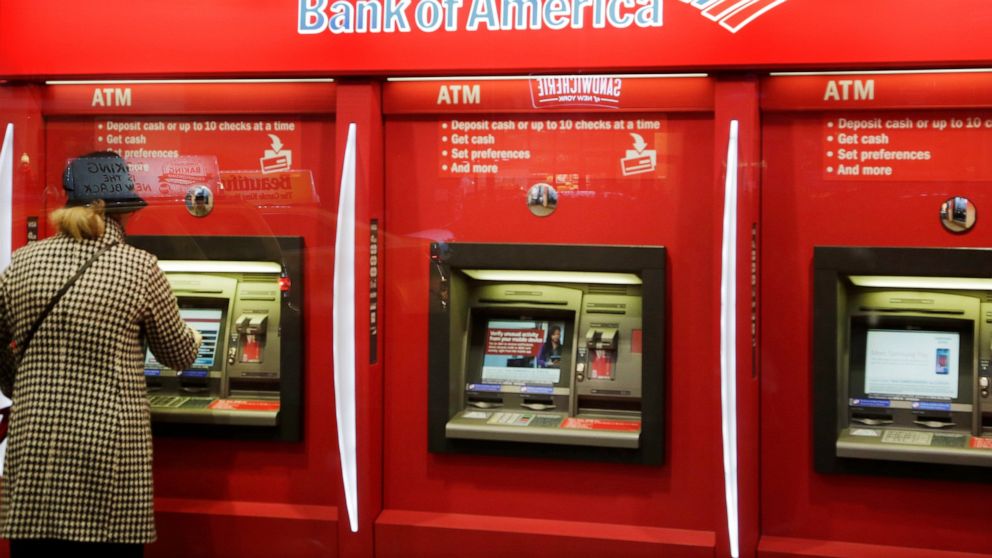 FILE - In this Nov. 23, 2015 file photo, a customer uses an ATM at a Bank of America in New York. The banking industry collectively made $233.1 billion in profits in 2019, the Federal Deposit Insurance Corporation said Tuesday, Feb. 25, 2020, the ind
