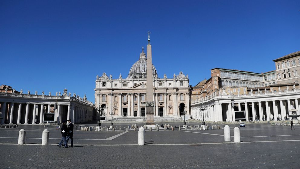 FILE - Policemen patrol an empty St. Peter's Square at the Vatican, Sunday, April 4, 2021. One of the principal figures in the Vatican’s bungled London real estate venture testified Monday, June 6, 2022 that the Holy See would have turned a profit on
