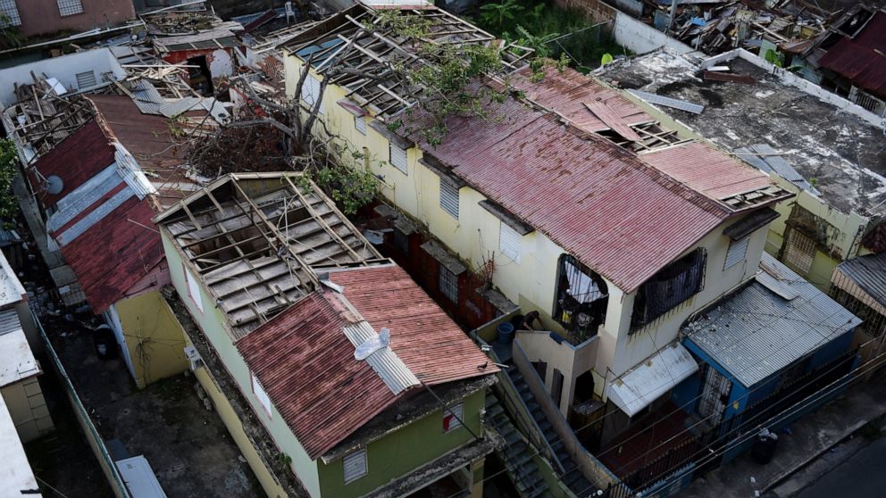 FILE - In this Nov. 15, 2017 photo, some roofs damaged by the whip of Hurricane Maria are shown still exposed to rainy weather conditions, in San Juan, Puerto Rico. Despite the potential for hurricanes and other natural disasters, many small business