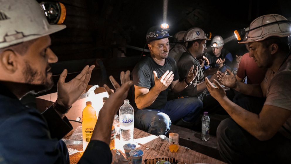 Bosnian coal miners pray after breaking fast in the underground at a mine in Zenica, Bosnia, Thursday, April 29, 2021. Inside mine shafts, one can't see sunset, but miners consult their watches and smartphones for the right time to sit down, unwrap t