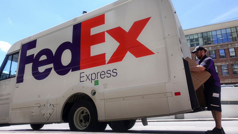 FILE - In this June 25, 2019, file photo a FedEx delivery truck is loaded by an employee on the street in downtown Cincinnati. FedEx reports financial results Tuesday, Sept. 17. (AP Photo/John Minchillo, File)