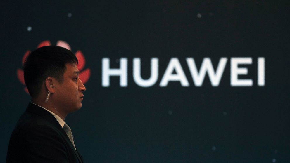 In this Jan. 9, 2019, photo, a security guard stands near the Huawei company logo during a new product launching event in Beijing. The Chinese Foreign Ministry said late Friday, Jan. 11, 2019, it is "closely following the detention of Huawei employee