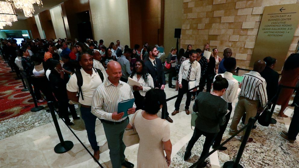 In this Tuesday, June 4, 2019 photo, job applicants line up at the Seminole Hard Rock Hotel & Casino Hollywood during a job fair in Hollywood, Fla. On Friday, June 7, the U.S. government issues the May jobs report. (AP Photo/Wilfredo Lee)