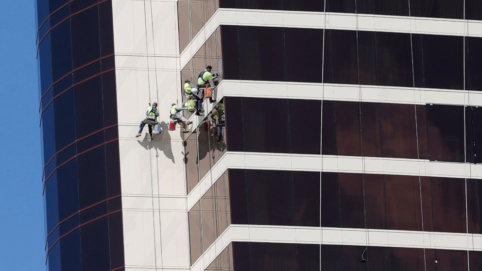 FILE - In this May 22, 2019, file photo window washers work on Encore Boston Harbor in Everett, Mass. On Thursday, June 6, the Labor Department issues revised data on productivity in the first quarter. (AP Photo/Michael Dwyer, File)