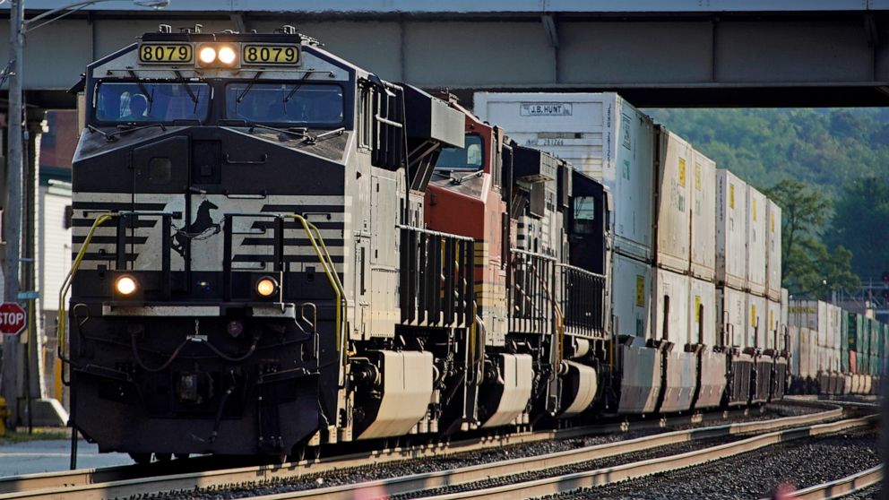FILE - A Norfolk Southern freight train runs through a crossing on Sept. 14, 2022, in Homestead, Pa. Norfolk Southern hauled in 27% more third-quarter profit, Wednesday, Oct. 26, as the railroad increased shipping rates and reduced the number of dela