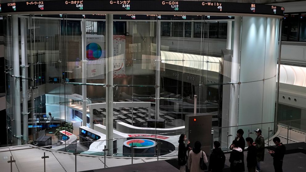 Visitors are seen at the Tokyo Stock Exchange on Dec. 12, 2022, in Tokyo, Japan. Shares rose Monday Dec. 26, 2022, in Asia in thin post-Christmas holiday trading, with markets in Hong Kong, Sydney and several other places closed.(AP Photo/Shuji Kajiyama)