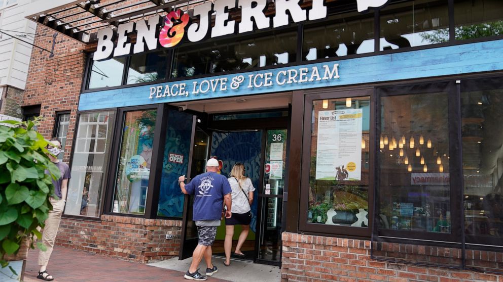 FILE - Two patrons enter the Ben & Jerry's Ice Cream shop, July 20, 2021, in Burlington, Vt. The Vermont-based ice cream maker is suing its corporate parent Unilever over a plan that would allow its product to be sold in east Jerusalem and the occupi
