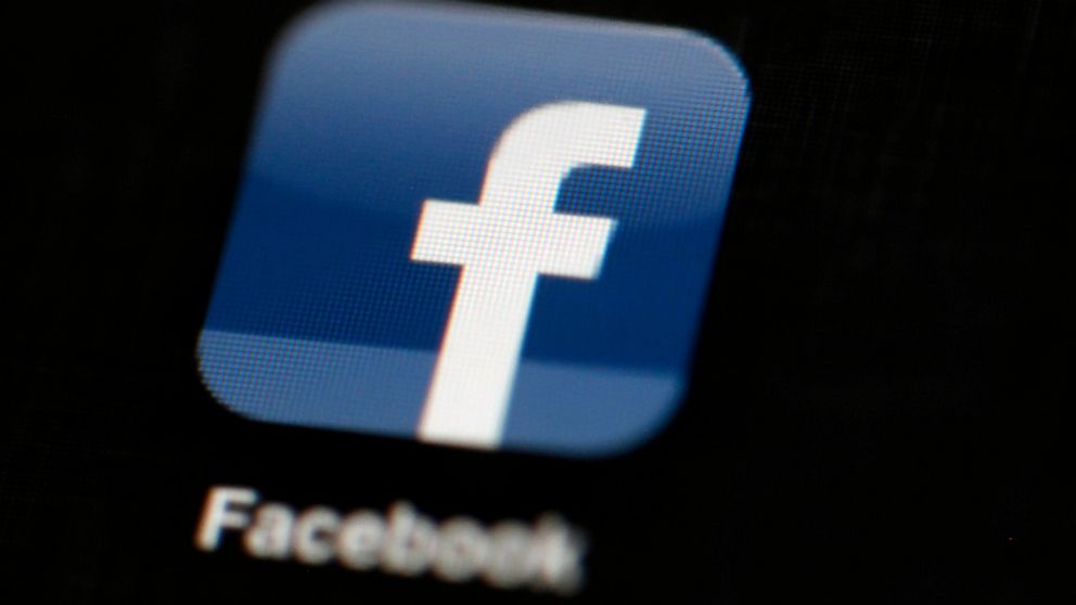 FILE - In this May 16, 2012, file photo, the Facebook logo is displayed on an iPad in Philadelphia. Facebook has removed hundreds more social media accounts that it says belonged to members of two different white supremacy groups. The company announc