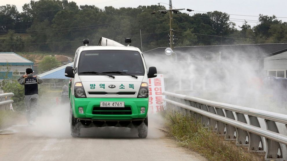Disinfectant solution is sprayed from a vehicle as a precaution against African swine fever near a pig farm in Paju, South Korea, Friday, Sept. 20, 2019. South Korea said Friday that it is investigating two more suspected cases of African swine fever
