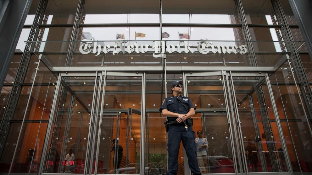 FILE- In this June 28, 2018, file photo, a police officer stands guard outside The New York Times building in New York. Shares of newspaper publisher The New York Times Co. slid Wednesday, Aug. 7, 2019, after the company said a key profit measure sli