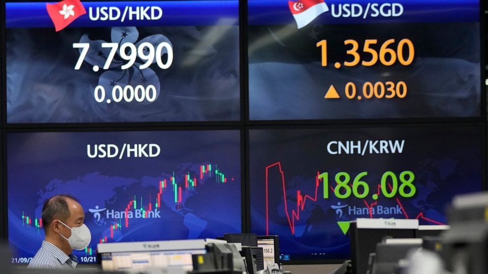 A currency trader watches monitors at the foreign exchange dealing room of the KEB Hana Bank headquarters in Seoul, South Korea, Monday, Dec. 27, 2021. Asian shares were mixed on Monday at the outset of the last trading week of the year as countries 
