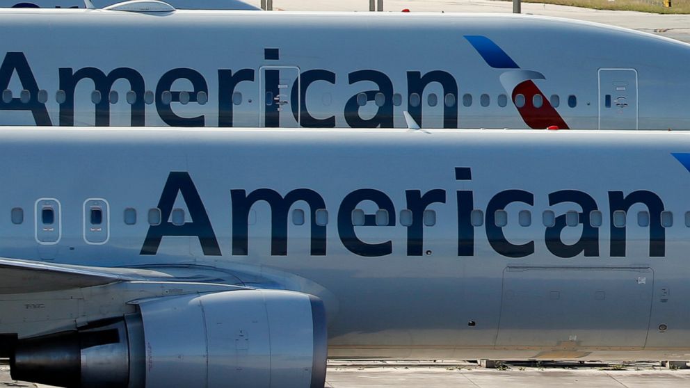 FILE - In this Monday, Nov. 6, 2017, file photo, a pair of American Airlines jets are parked on the airport apron at Miami International Airport in Miami. Pilots at another big airline are rejecting a contract offer to seek bigger pay raises. The All