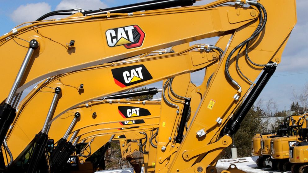 Excavator booms, adorned with the Caterpillar Inc. "CAT" logo are displayed at the Milton CAT dealership in Londonderry, N.H., Thursday, Feb. 20, 2020. Caterpillar's sales rose in the first quarter as market conditions for the machinery company begin