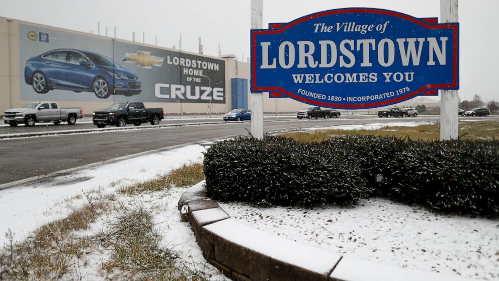 FILE- In this Nov. 27, 2018, file photo a banner depicting the Chevrolet Cruze model vehicle is displayed at the General Motors' Lordstown plant in Lordstown, Ohio. General Motors is selling the Ohio assembly plant it closed in March to a new company