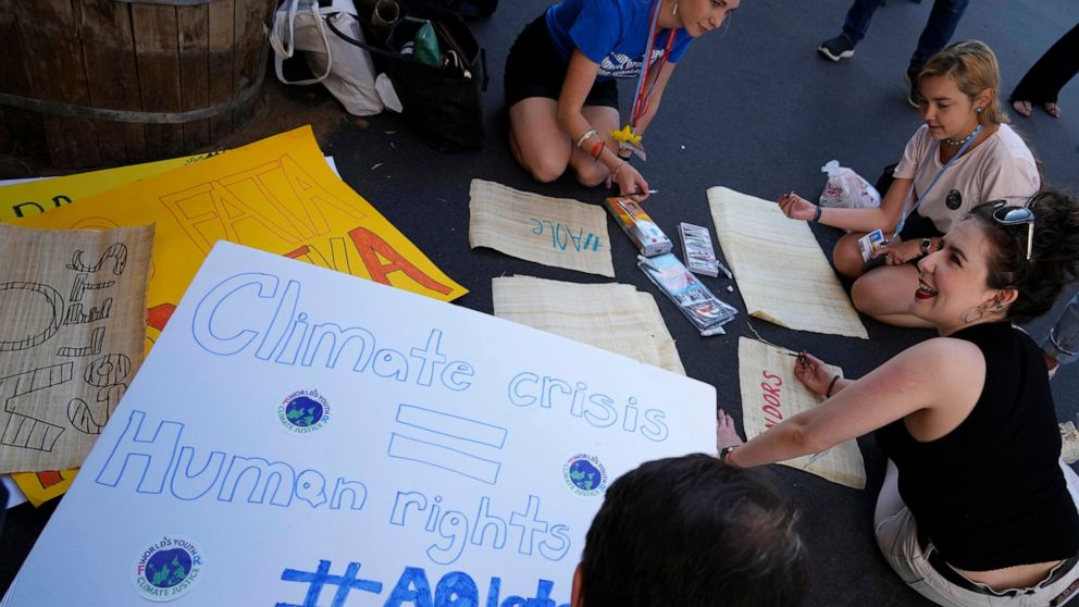 Activists work on signs ahead of demonstrations at the COP27 U.N. Climate Summit, Wednesday, Nov. 16, 2022, in Sharm el-Sheikh, Egypt. (AP Photo/Peter Dejong)