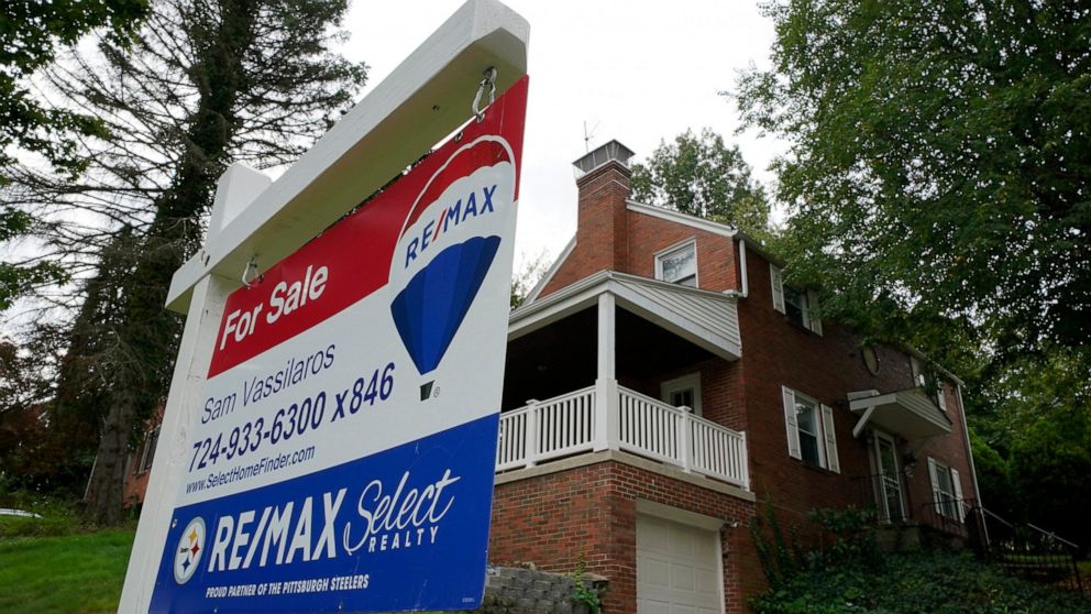 FILE - A for sale sign is displayed outside a home in Mount Lebanon, Pa., on Tuesday, Sept. 21, 2021. Sales of previously occupied U.S. homes slowed in March 2022, to the slowest pace in nearly two years as a swift rise in mortgage rates and record-h