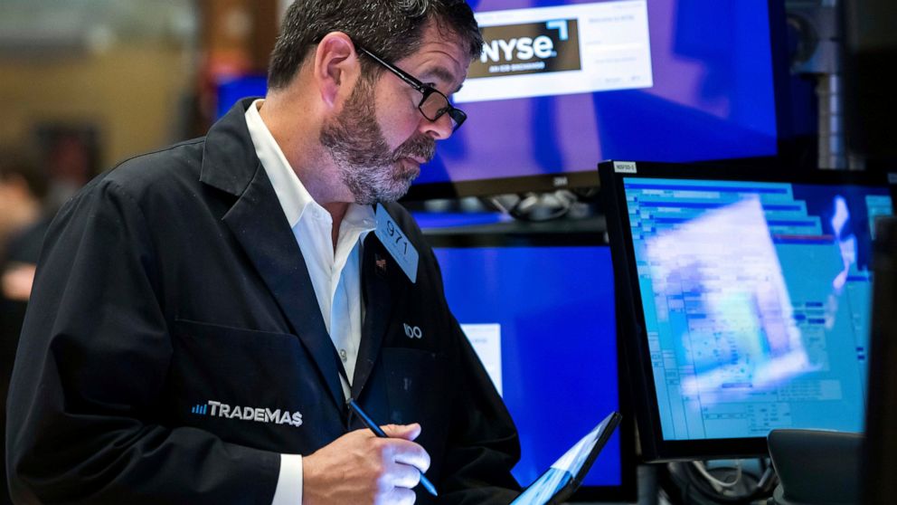 In this photo provided by the New York Stock Exchange, trader James MacGilvray works on the floor, Friday, May 13, 2022. Stocks rallied on Wall Street Friday, but not enough to claw back all the losses the market has taken in this volatile week of tr