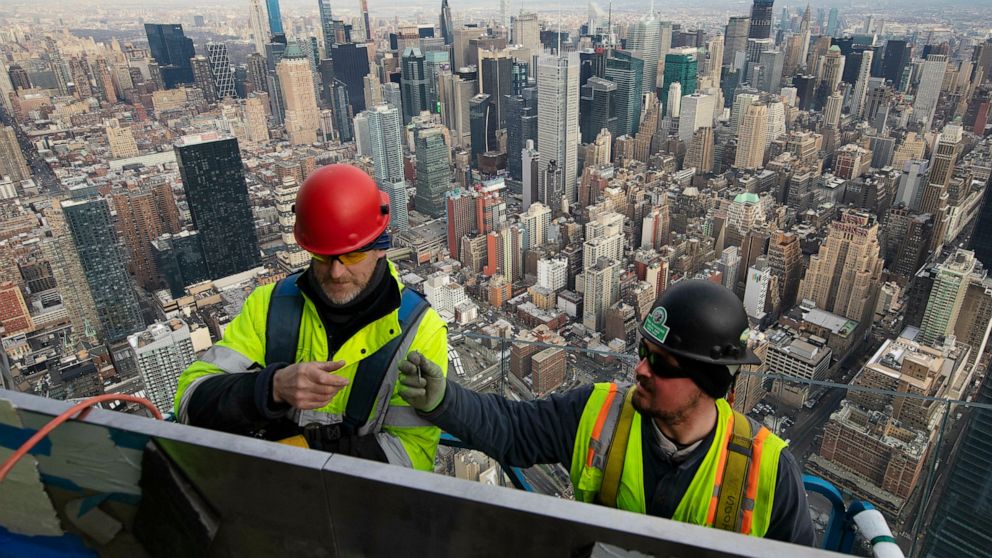 FILE - In this March 8, 2019, file photo, work continues on an outdoor observation deck on the 30 Hudson Yards office building in New York. Business economists expect U.S. economic growth to slow this year and next, but they say the economy will avoi