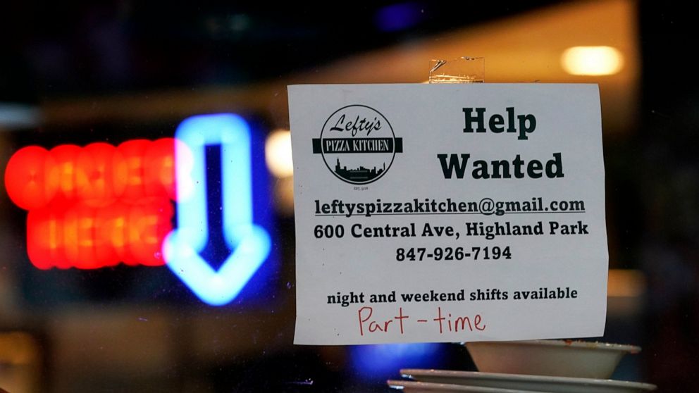 FILE - Hiring sign is displayed at a restaurant in Highland Park, Ill., Thursday, July 14, 2022. Fewer Americans filed for unemployment benefits last week as the labor market continues to shine despite weakening elements of the U.S. economy. Applicat