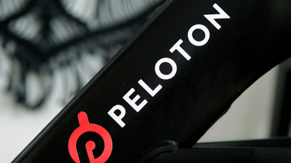 FILE - A Peloton logo is seen on the company's stationary bicycle on Nov. 19, 2019, in San Francisco. Peloton co-founders John Foley and Hisao Kushi have resigned from their roles at the high-end exercise bike maker as the company deals with falterin