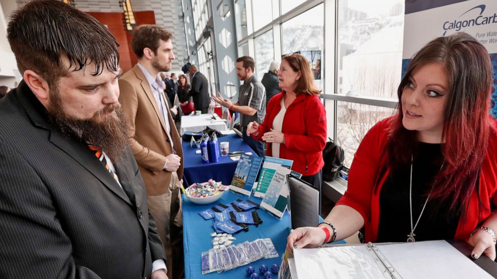 FILE - In this March 7, 2019, file photo visitors to the Pittsburgh veterans job fair meet with recruiters at Heinz Field in Pittsburgh. On Wednesday, June 5, payroll processor ADP reports how many jobs private employers added in May. (AP Photo/Keith