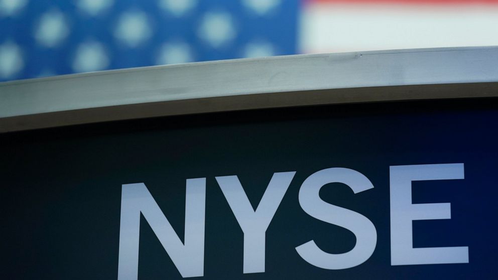 FILE- A sign for New York Stock Exchange is displayed on the floor at the NYSE in New York, Wednesday, July 27, 2022. Stocks were modestly higher early Friday, July 29, 2022, on Wall Street, despite news that closely watched inflation data jumped by 
