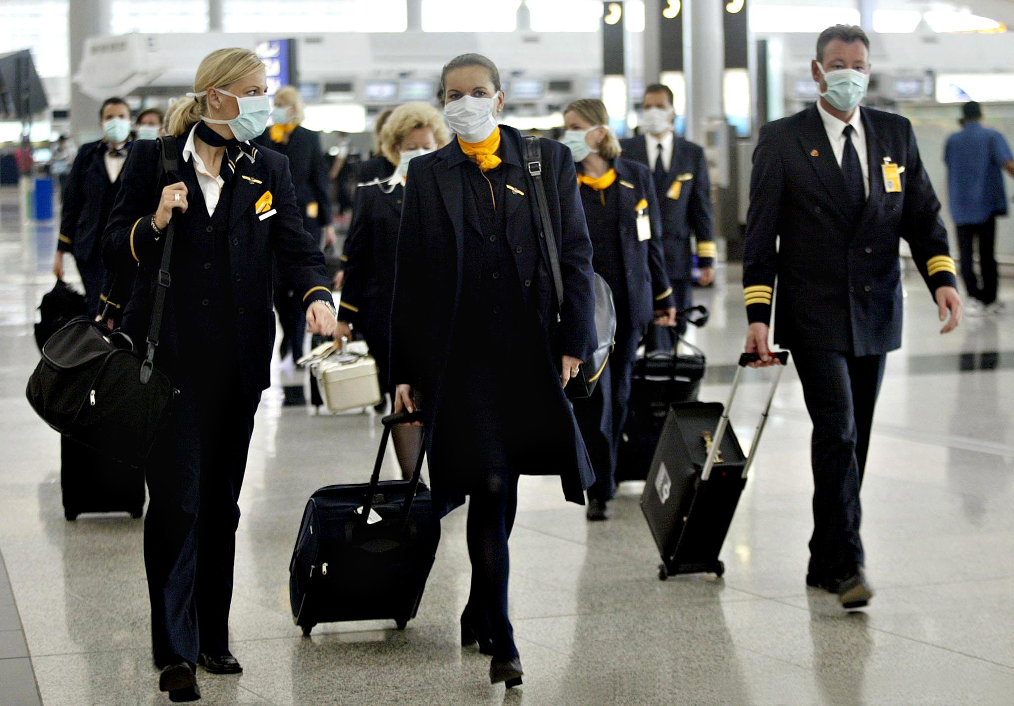 PHOTO: Aircrew for Germany's Lufthansa airline wearing masks during a pneumonia outbreak in 2003. 