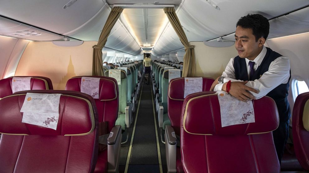 PHOTO: A flight attendant on a near-empty Myanmar National airlines flight from Yangon to Suvarnabhumi International airport, March 4, 2020 during  the flight.
