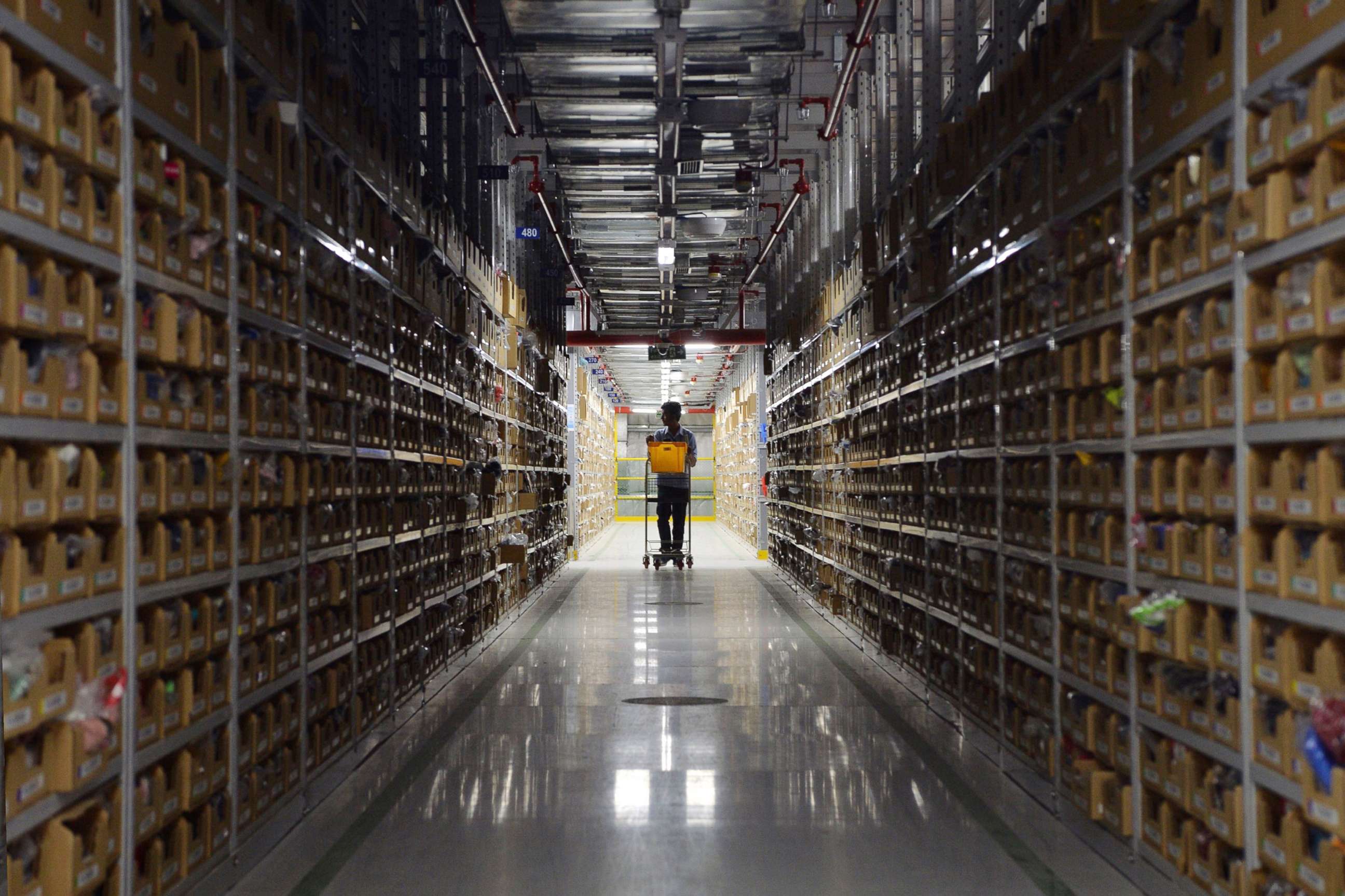 PHOTO: An employee of Amazon India retrieves products for delivery at Amazon's fulfillment center in Bangalore, Sept. 18, 2018.