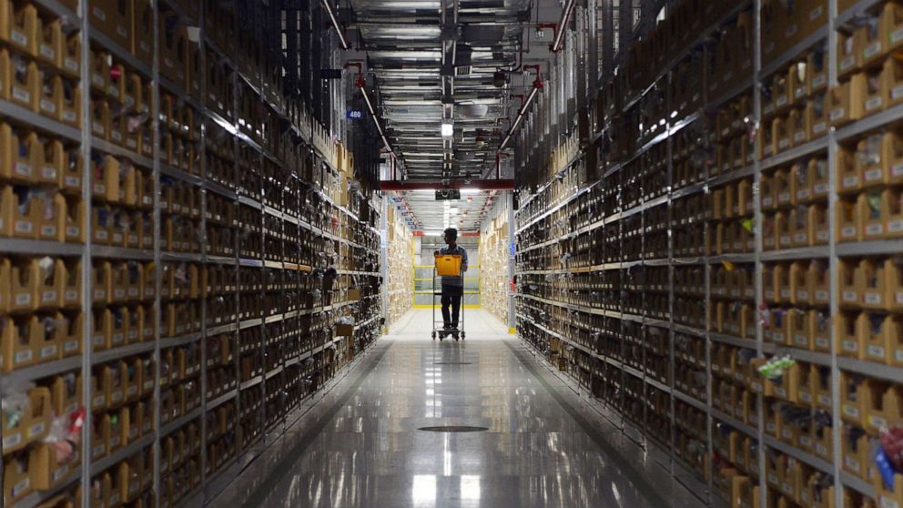 PHOTO: An employee of Amazon India retrieves products for delivery at Amazon's fulfillment center in Bangalore, Sept. 18, 2018.