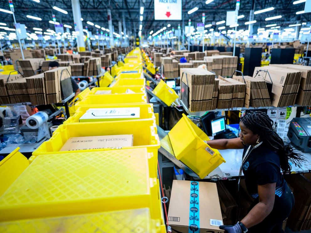 PHOTO: In this file photo taken on February 5, 2019 a woman works at a packing station at the 855,000-square-foot Amazon fulfillment center in Staten Island, New York.
