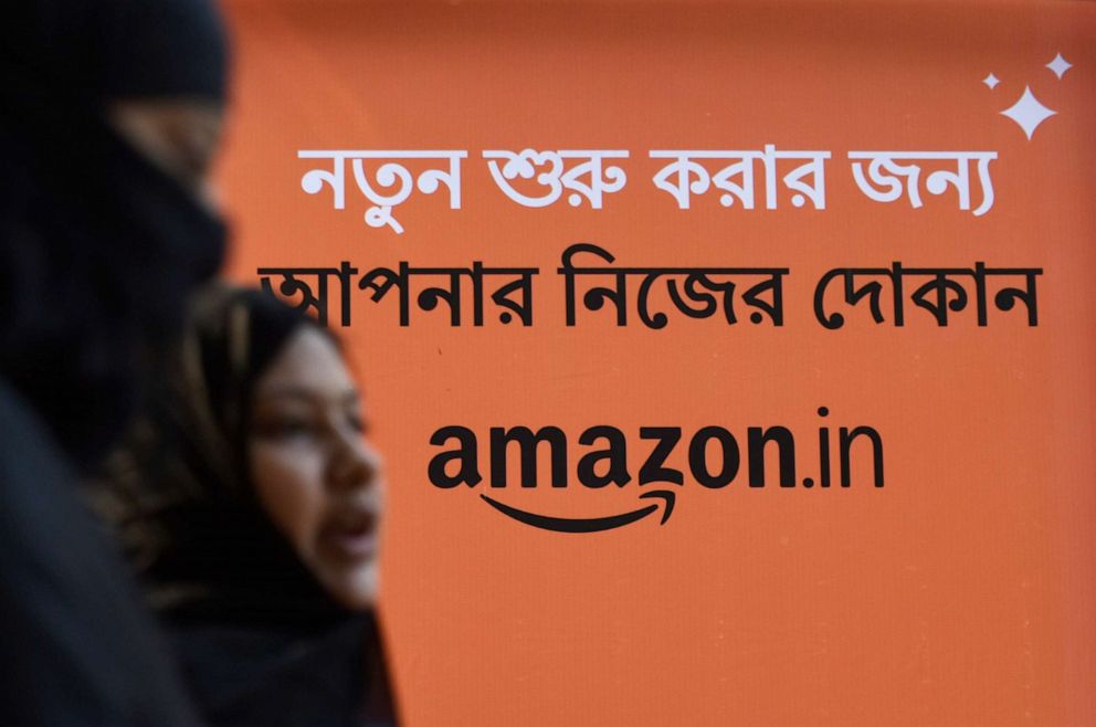 PHOTO: Women walk past an Amazon billboard in Kolkata, India, Feb. 28, 2020. 