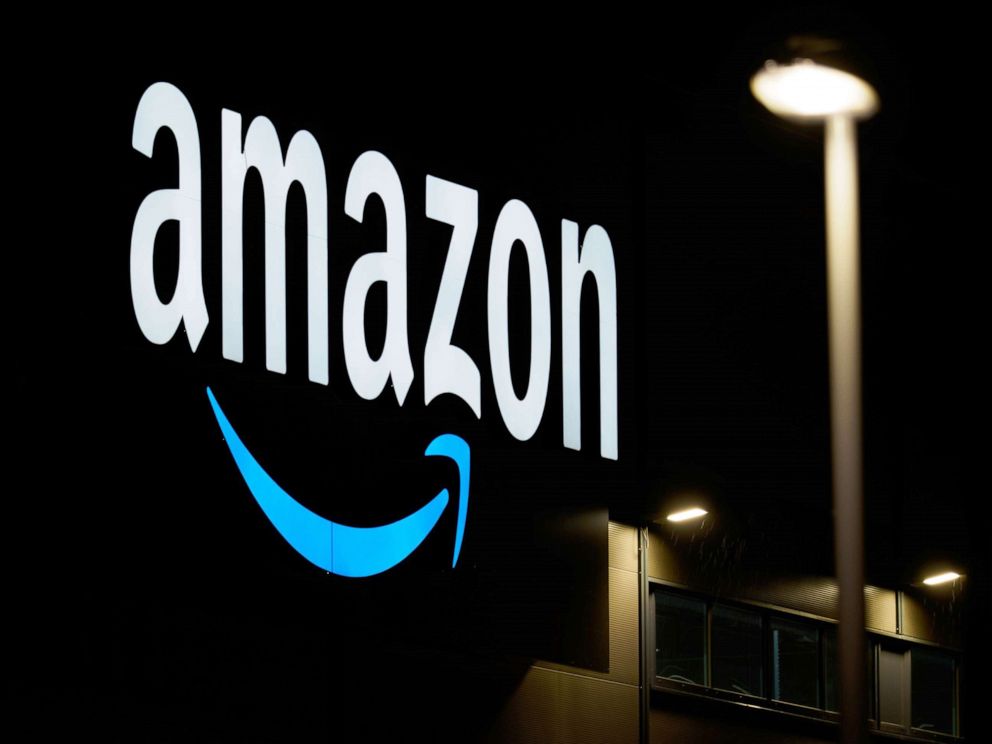 PHOTO:An Amazon company sign is illuminated at a sorting center in Brandenburg, Germany, Dec. 17, 2020.