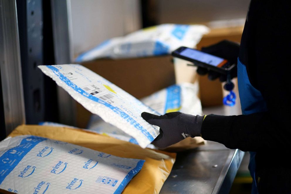 PHOTO: An Amazon worker delivers packages amid the coronavirus disease (COVID-19) outbreak in Denver, Colorado, April 22, 2020.