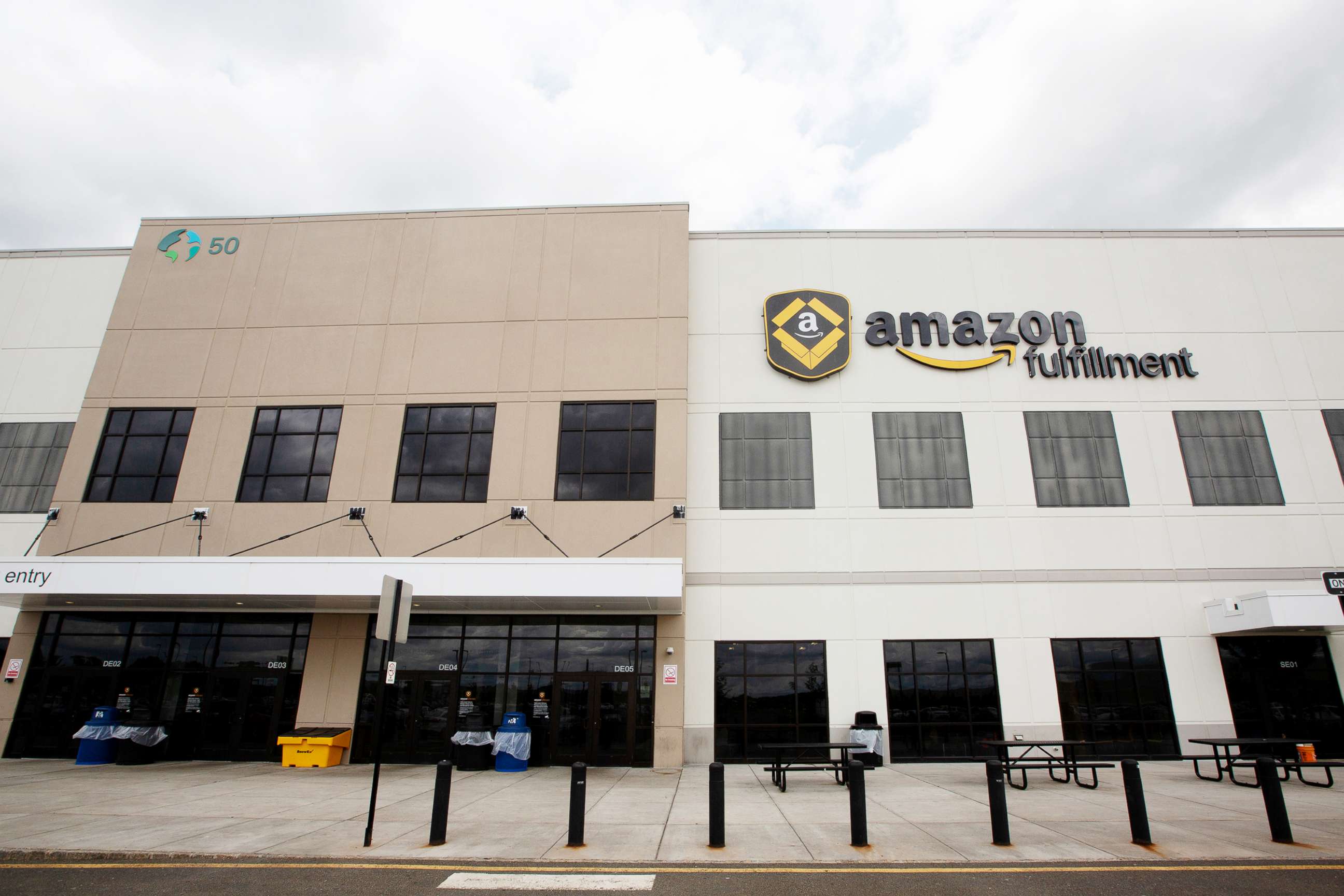 PHOTO: Signage for Amazon is displayed atop the company's fulfillment center in Robbinsville, N.J., June 7, 2018.