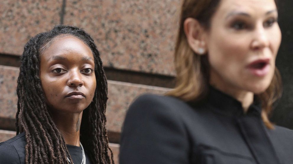 PHOTO: Amazon worker Tori Davis listens during a news conference outside an Amazon Go in Chicago. July 27, 2022.