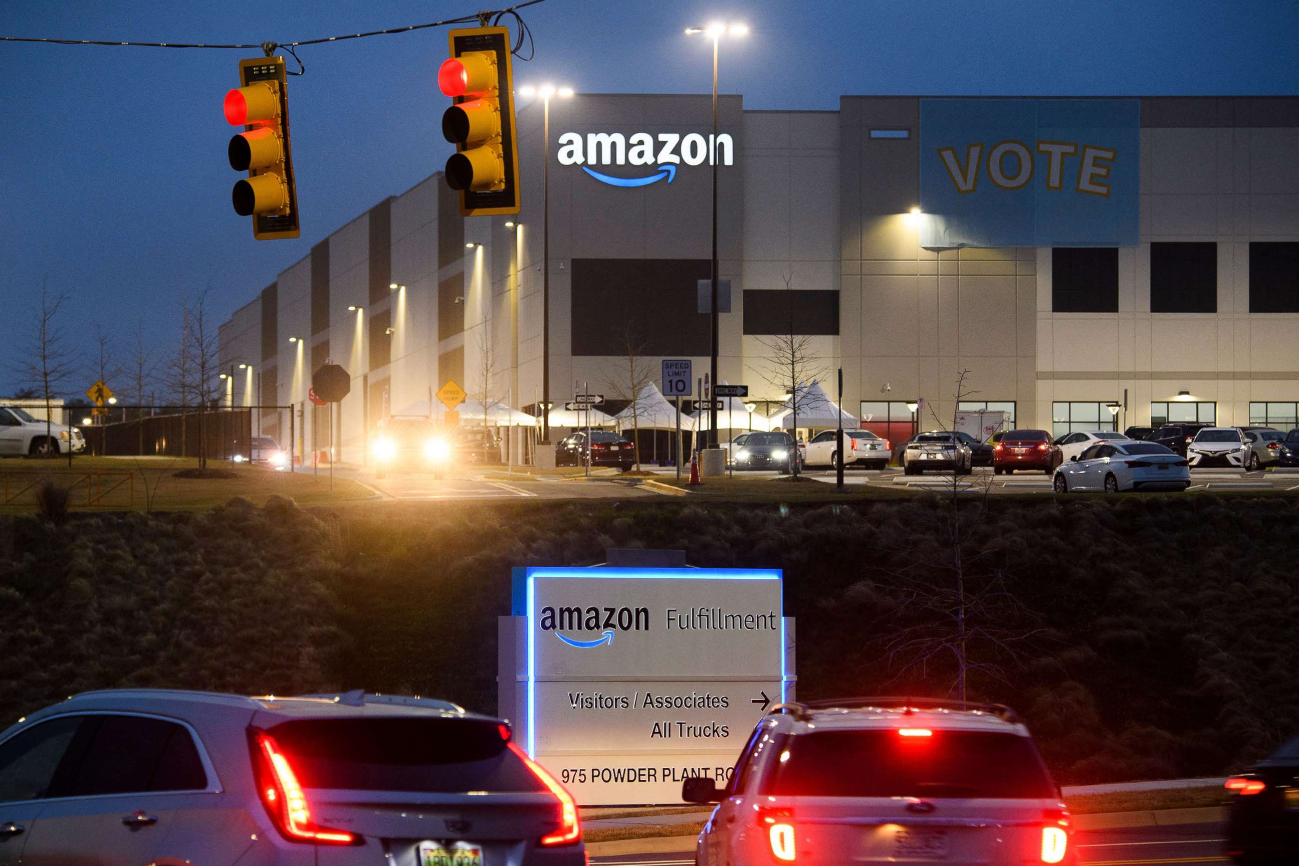 PHOTO: A Vote banner hangs at an Amazon fulfillment center on March 27, 2021 in Bessemer, Ala. Amazon Alabama workers are trying to unionize with the Retail, Wholesale and Department Store Union (RWDSU) in Birmingham.