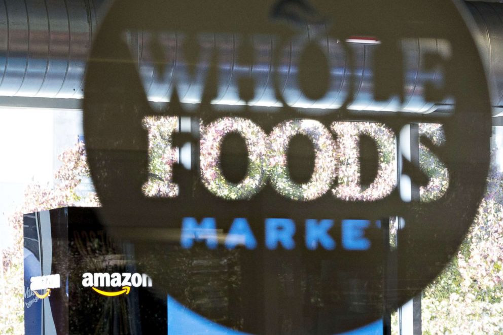 PHOTO: Amazon.com Inc. signage is displayed at a Pop-Up store inside the Lakeview Whole Foods Market Inc. store in Chicago, Illi, on Nov. 20, 2017.
