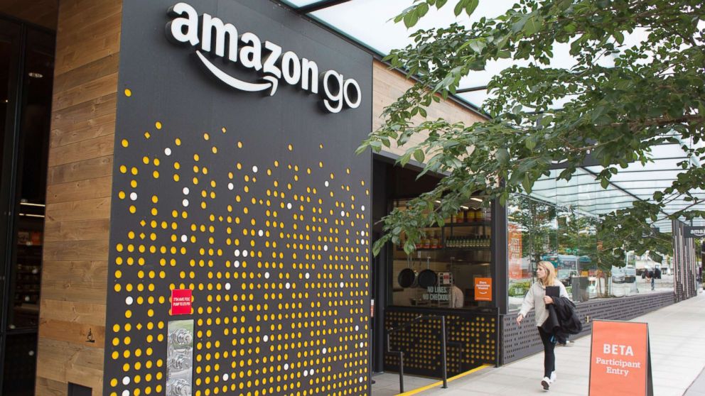 A woman walks past the Amazon Go grocery store at the Amazon corporate headquarters on June 16, 2017, in Seattle.