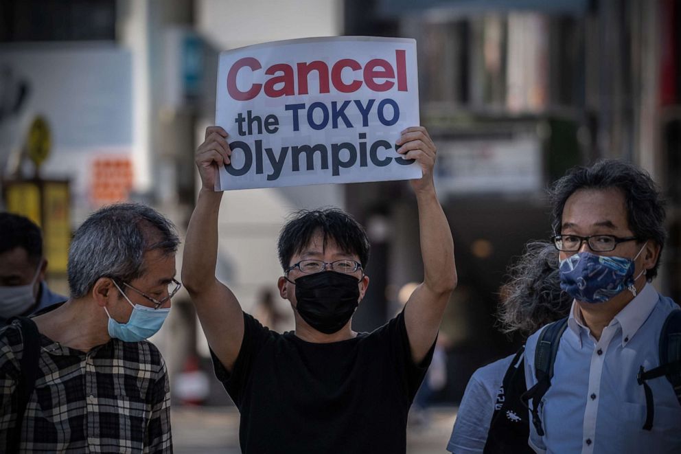 PHOTO: A protester holds a placard during a demonstration against the forthcoming Tokyo Olympic Games, May 23, 2021, in Tokyo.