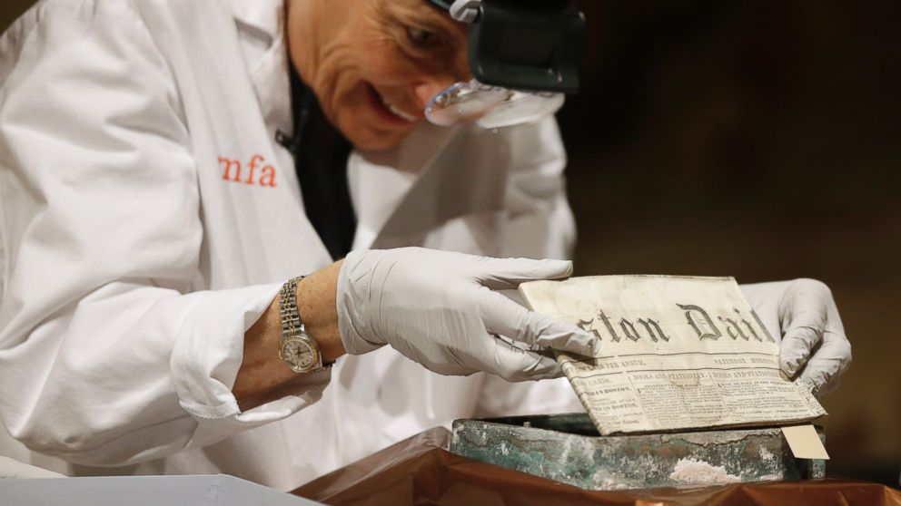 PHOTO: Museum of Fine Arts Boston Head of Objects Conservation Pam Hatchfield removes a folded 19th century newspaper from a time capsule at the museum, Jan. 6, 2015, in Boston. 