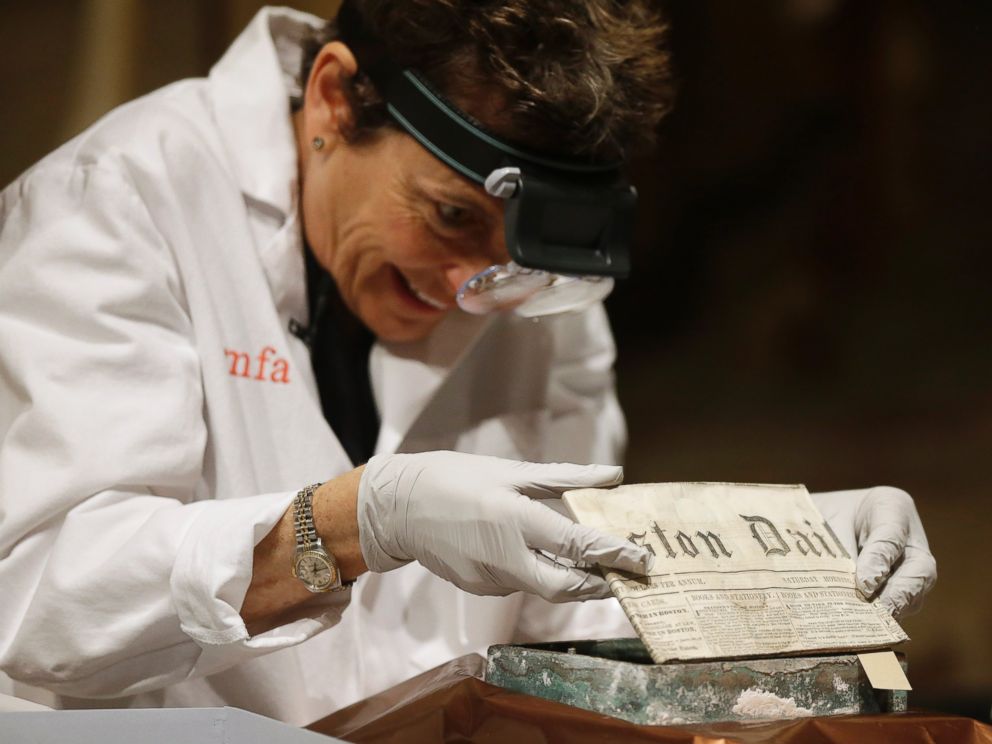 PHOTO: Museum of Fine Arts Boston Head of Objects Conservation Pam Hatchfield removes a folded 19th century newspaper from a time capsule at the museum, Jan. 6, 2015, in Boston. 
