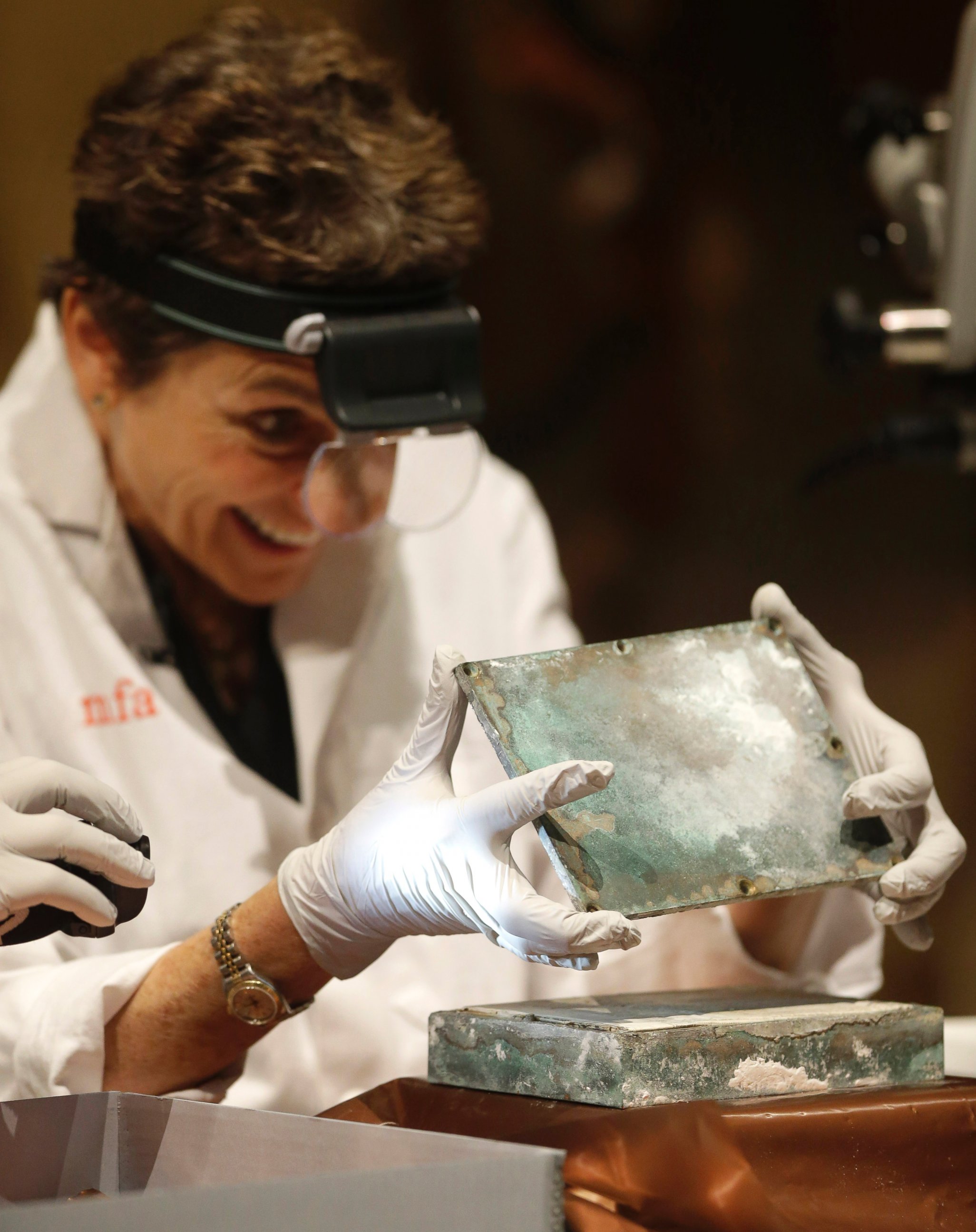PHOTO: Museum of Fine Arts Boston Head of Objects Conservation Pam Hatchfield removes a metal lid from a time capsule at the museum, Jan. 6, 2015, in Boston. 