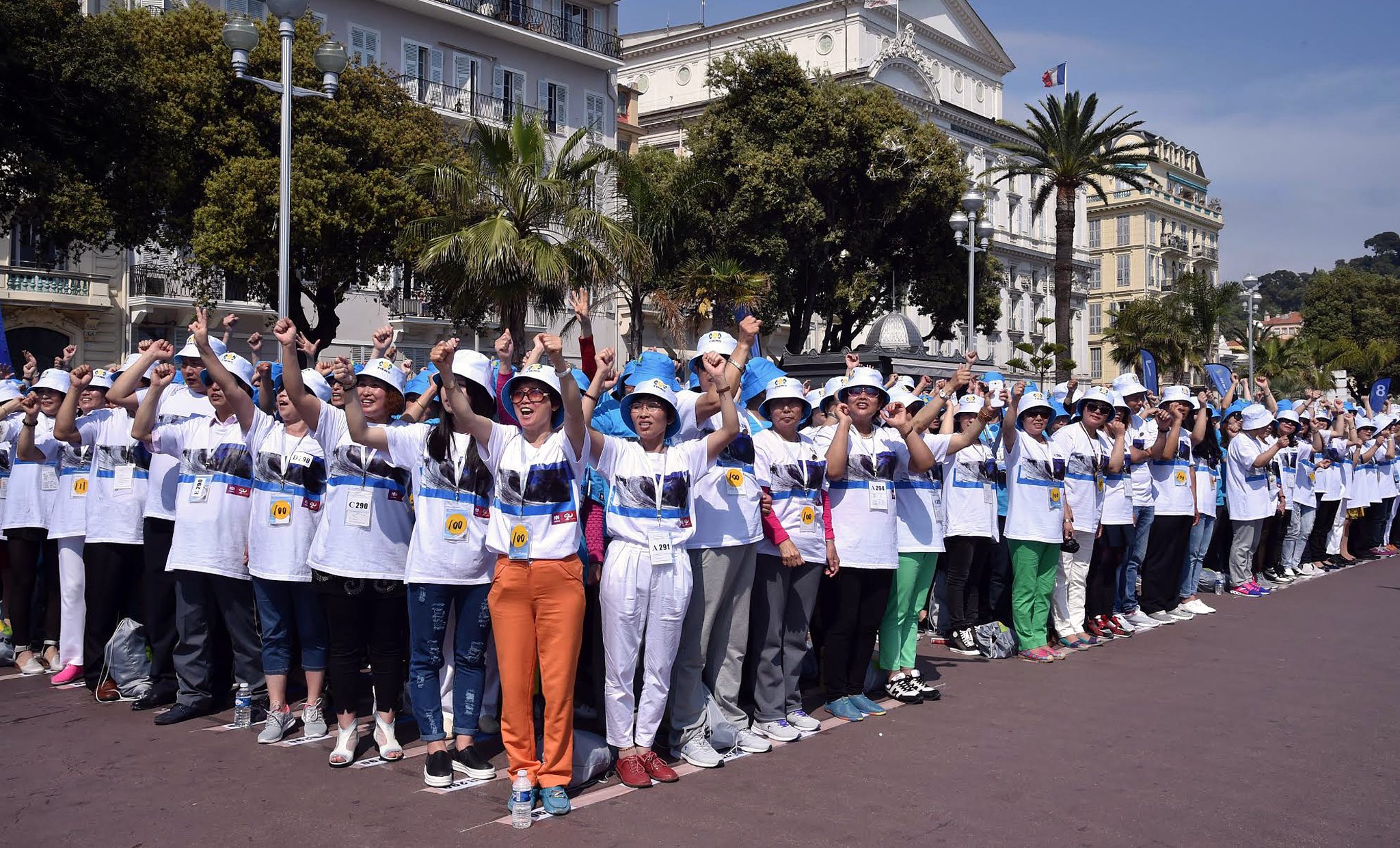 PHOTO: Employees of Chinese company 'Tiens' attend a parade on the Promenade des Anglais in Nice, southeastern France, May 8, 2015.