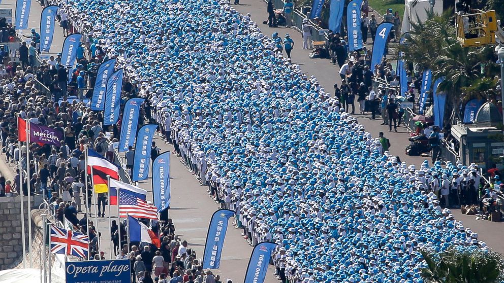 PHOTO: Employees of the TIENS Group attend a parade organized by CEO Li Jinyuan as part of a four-day celebration weekend for the 20th anniversary of his company, on the Promenade des Anglais, Nice, France, May 8, 2015.