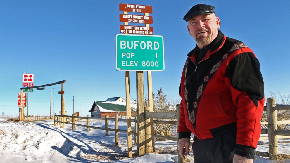 Buford resident Don Sammons stands in front of the population sign for the town of Buford, Wyo.