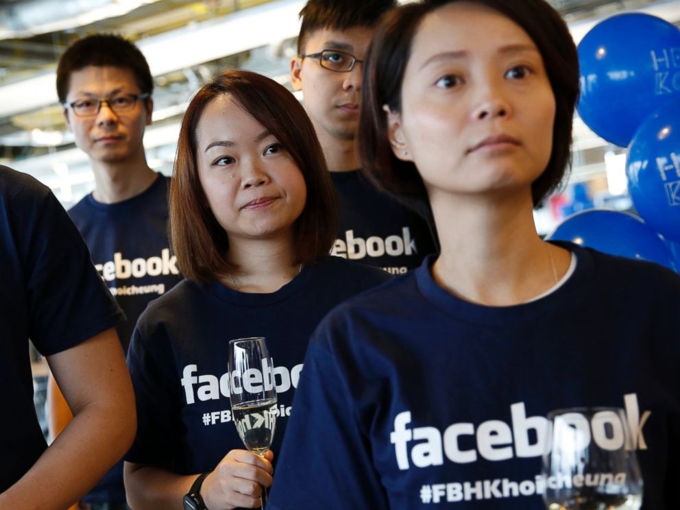 PHOTO: Facebook staff members attend the opening ceremony of their new office in Hong Kong, July 24, 2014.