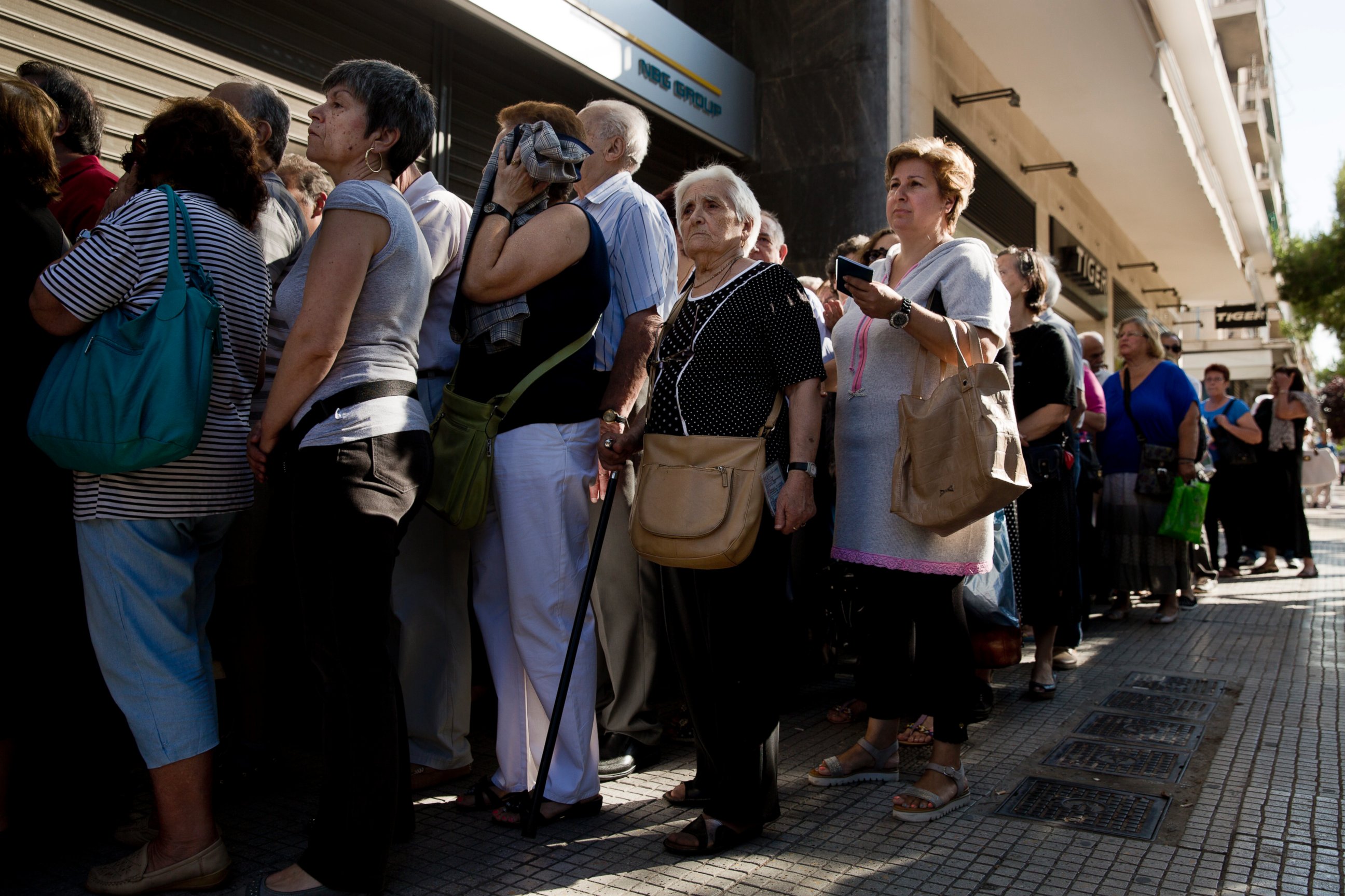 PHOTO: Pensioners line up as the wait to be allowed into a bank in Athens, July 1, 2015 , and withdraw a maximum 120 euros for the week, during capital controls in Greece.