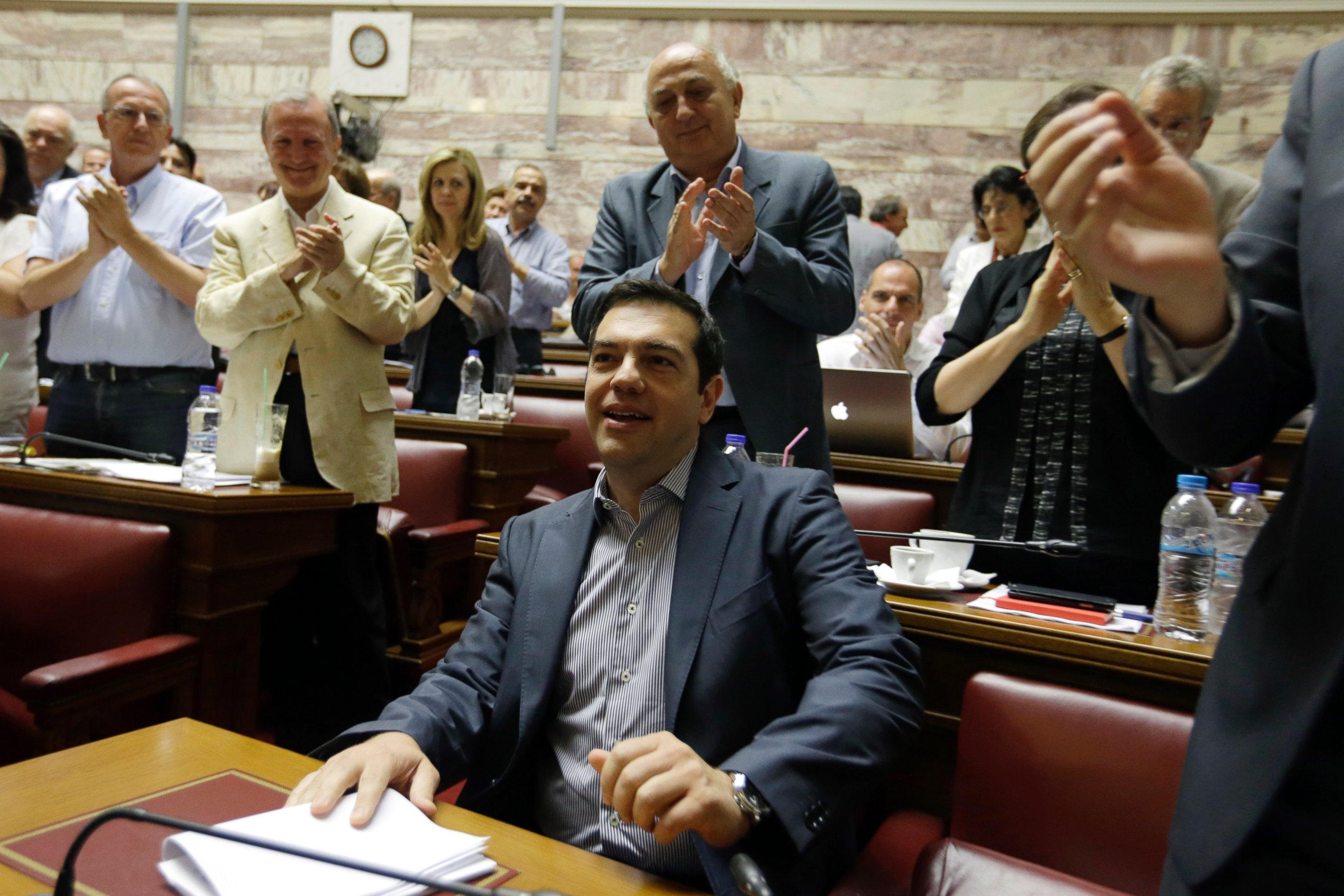 PHOTO: Greece's Prime Minister Alexis Tsipras arrives for a meeting as his lawmakers of Syriza party applaud him at the Greek Parliament in Athens, July 10, 2015.