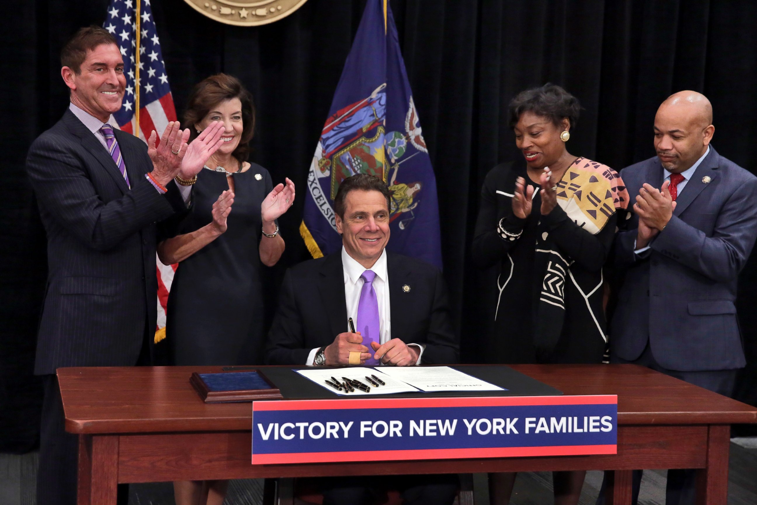 PHOTO: New York Gov. Andrew Cuomo is applauded after he signed a law that will gradually raise New York's minimum wage to $15 at the Javits Convention Center in New York, Monday, April 4, 2016.